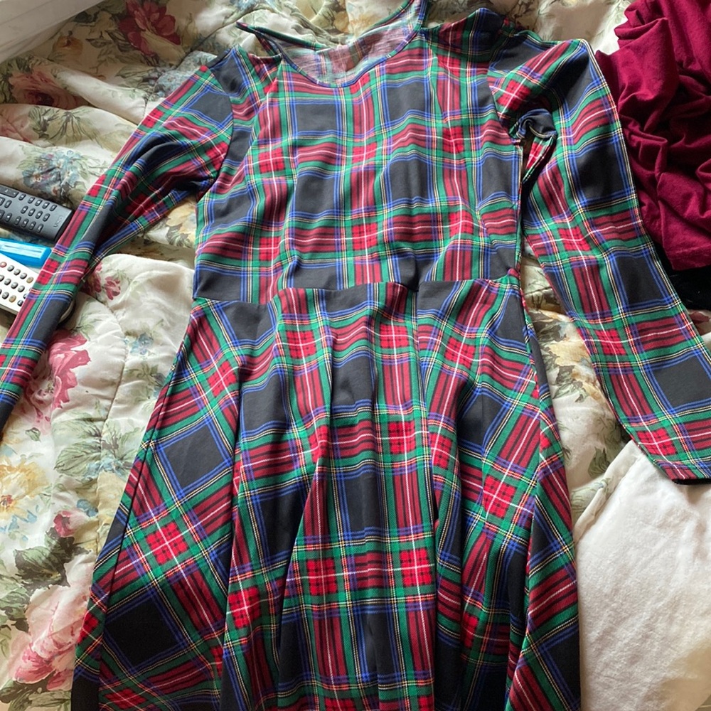 A plaid long sleeve open shoulder dress for a girl